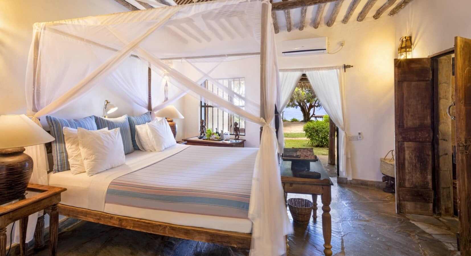 Swahili-style four-poster suite with carved wooden doors