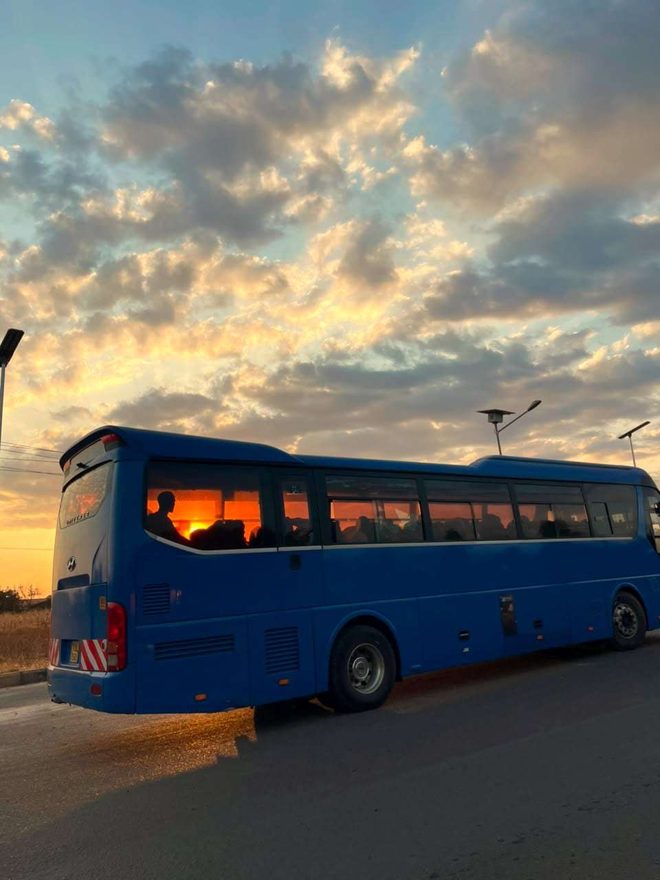 Tour bus ready for a group trip at sunset