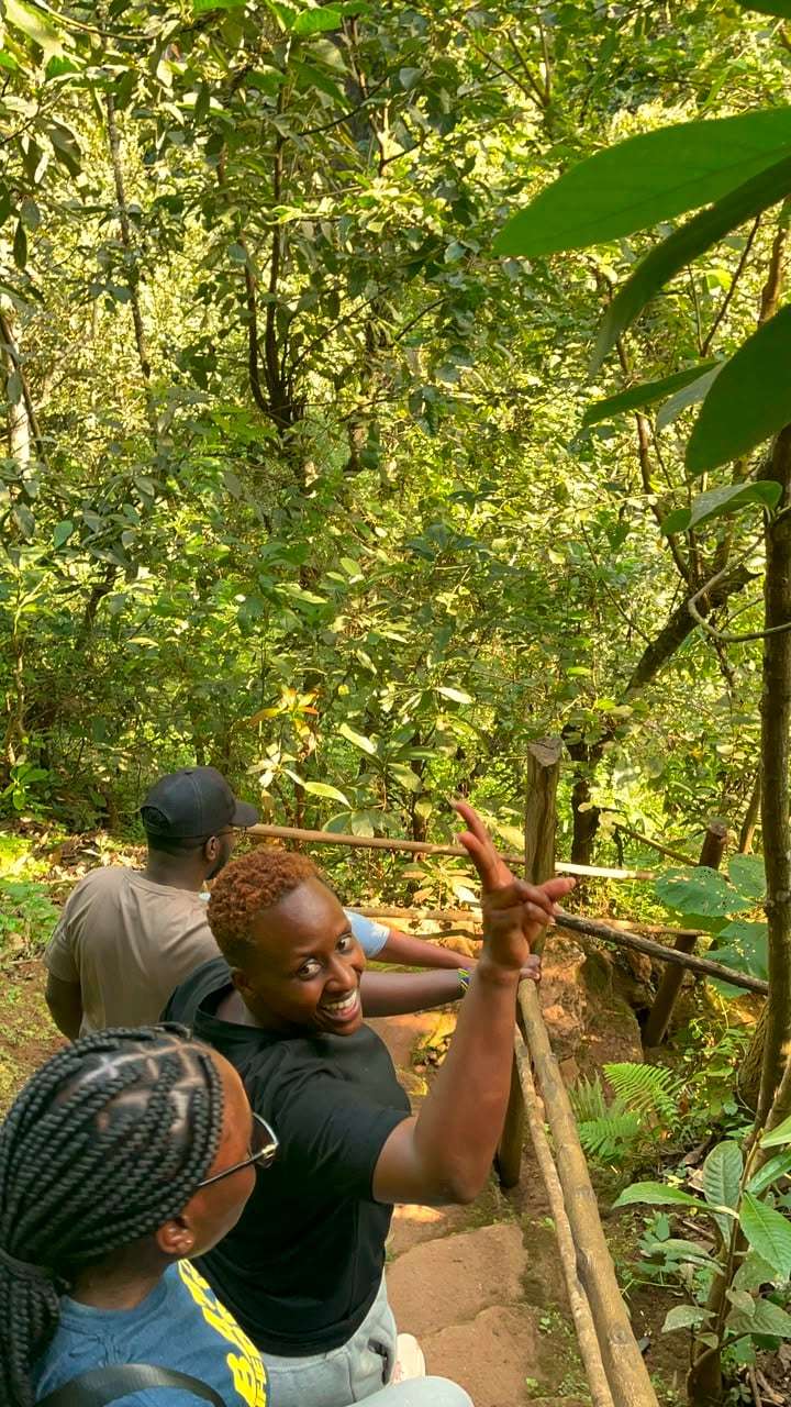 Smiling travellers resting together on a forest trail hike