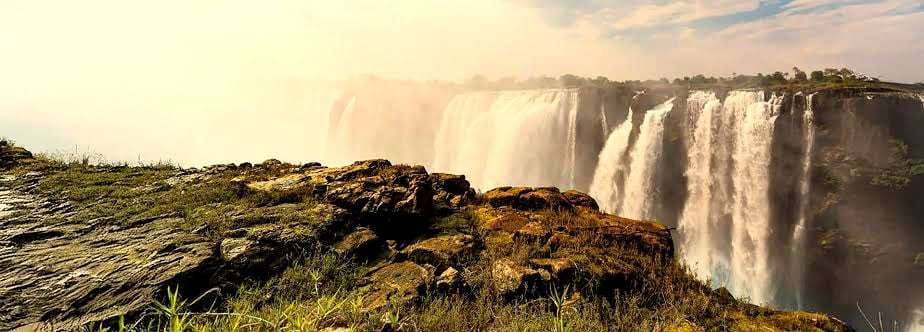 Victoria Falls pouring into the Zambezi gorge, seen from the rocky edge